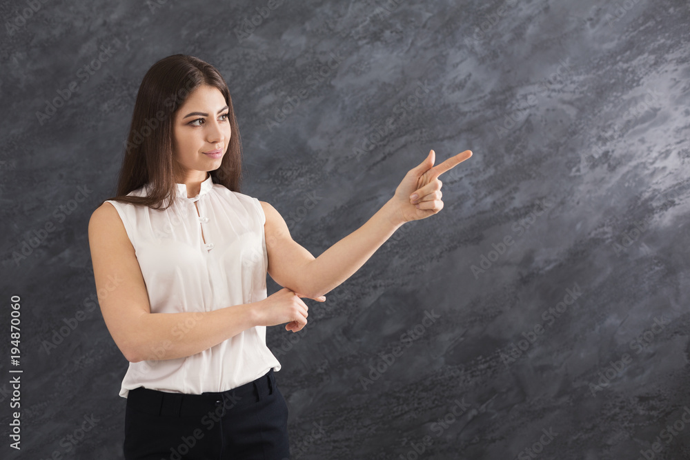Smiling woman showing something, point finger up