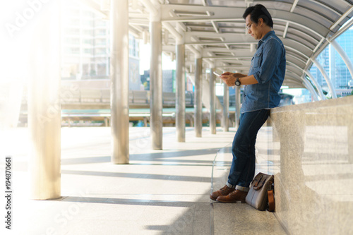 Man use of tablet computer in the city