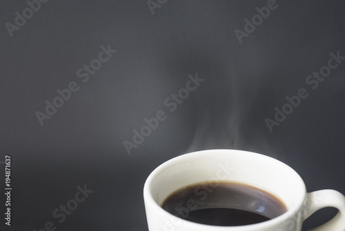 coffee with smoke ready to drink on a gray background with empty