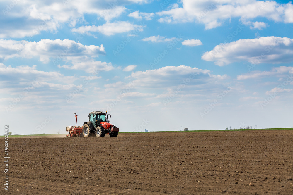 Farmer seeding, sowing crops at field. Sowing is the process of planting seeds in the ground as part of the early spring time agricultural activities. Farmer seeding, sowing crops at field. Sowing is the process of planting seeds in the ground as part of the early spring time agricultural activities.