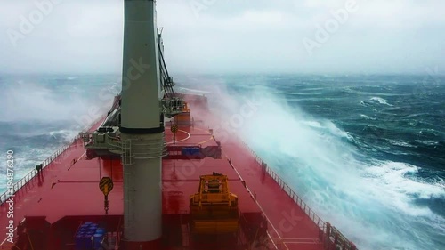 Cargo ship sailing through violent storm. Wind speed 11 as per Beaufort scale. Very large patches of foam, driven before the wind, cover much of the sea surface. Oct, 2017. Pacific, Japanese coast