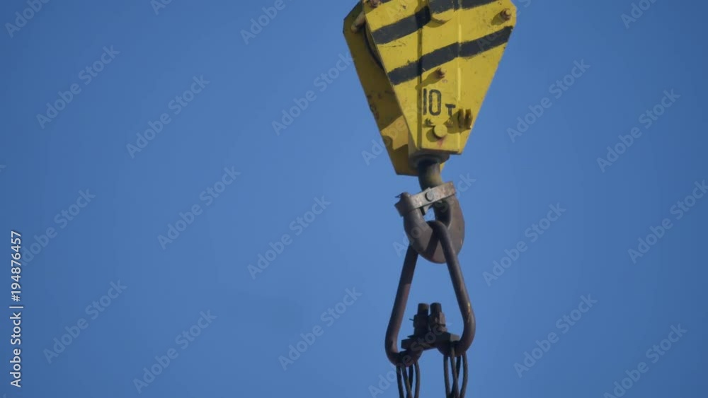 The hook of the elevating crane on blue industry background construction The hook of the elevating crane on blue industry background construction