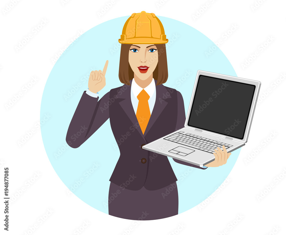 Businesswoman in construction helmet holding a laptop notebook and pointing up Businesswoman in construction helmet holding a laptop notebook and pointing up