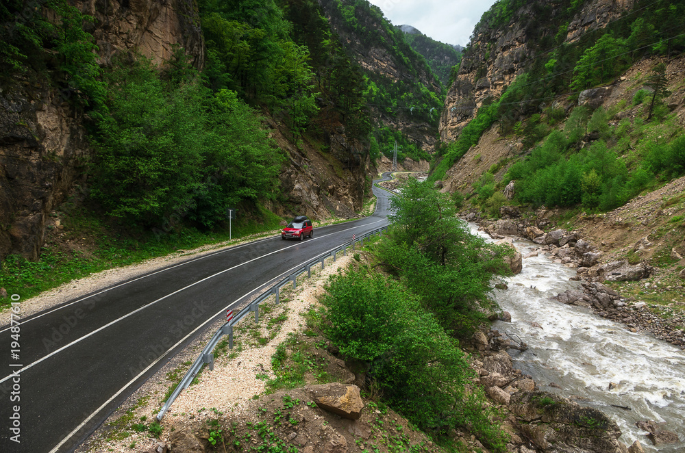 Red car on mountain road