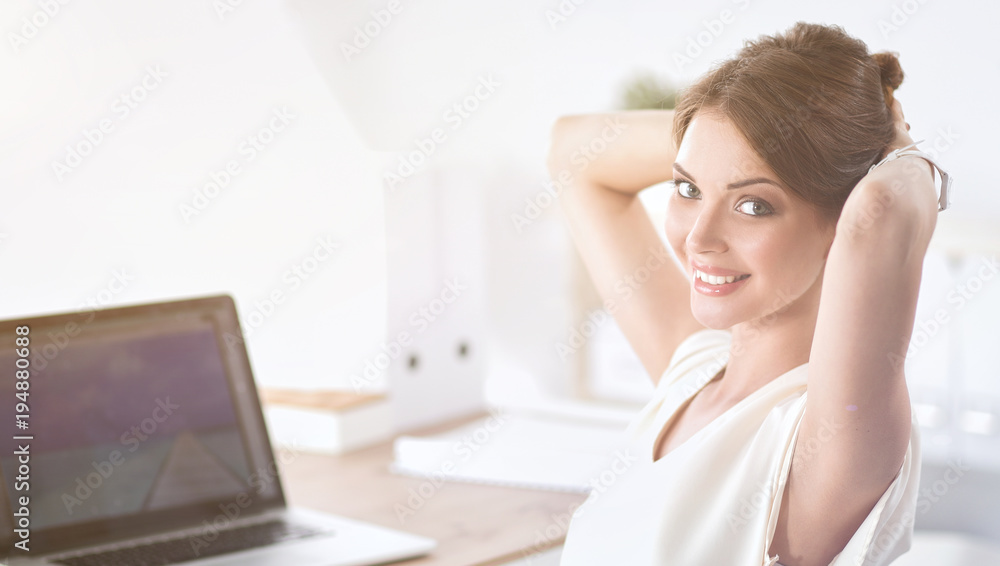 Business woman relaxing with hands behind her head and sitting on an office chair Business woman relaxing with hands behind her head and sitting on an office chair