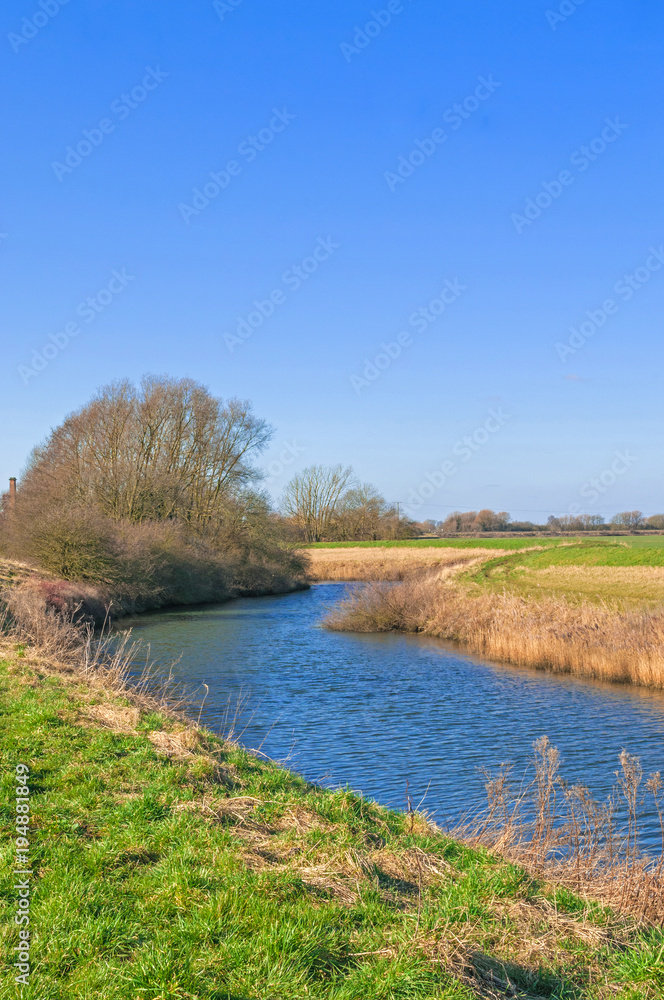 Steep banked river in winter, river Idle West Stockwith Nottinghamshire Steep banked river in winter, river Idle West Stockwith Nottinghamshire