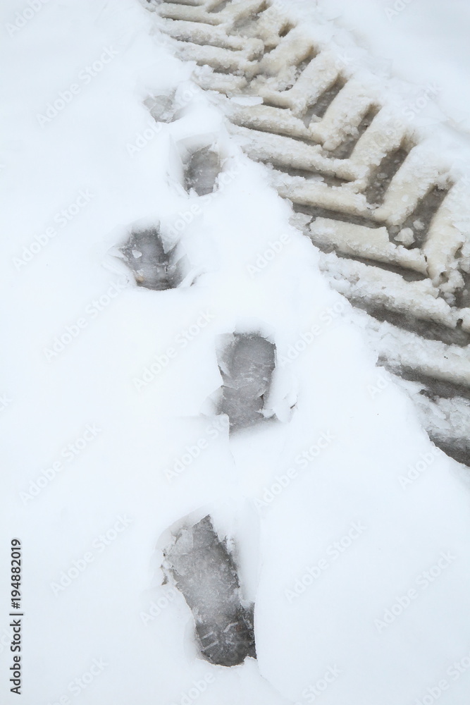 Footprint and tyre track on the snow Footprint and tyre track on the snow
