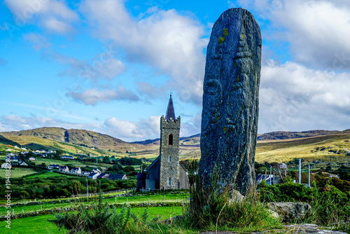 The standing stone is called a Turas it was created between the eighth and ninth century it stands outside the Church of Ireland in Glencolmcille. photo