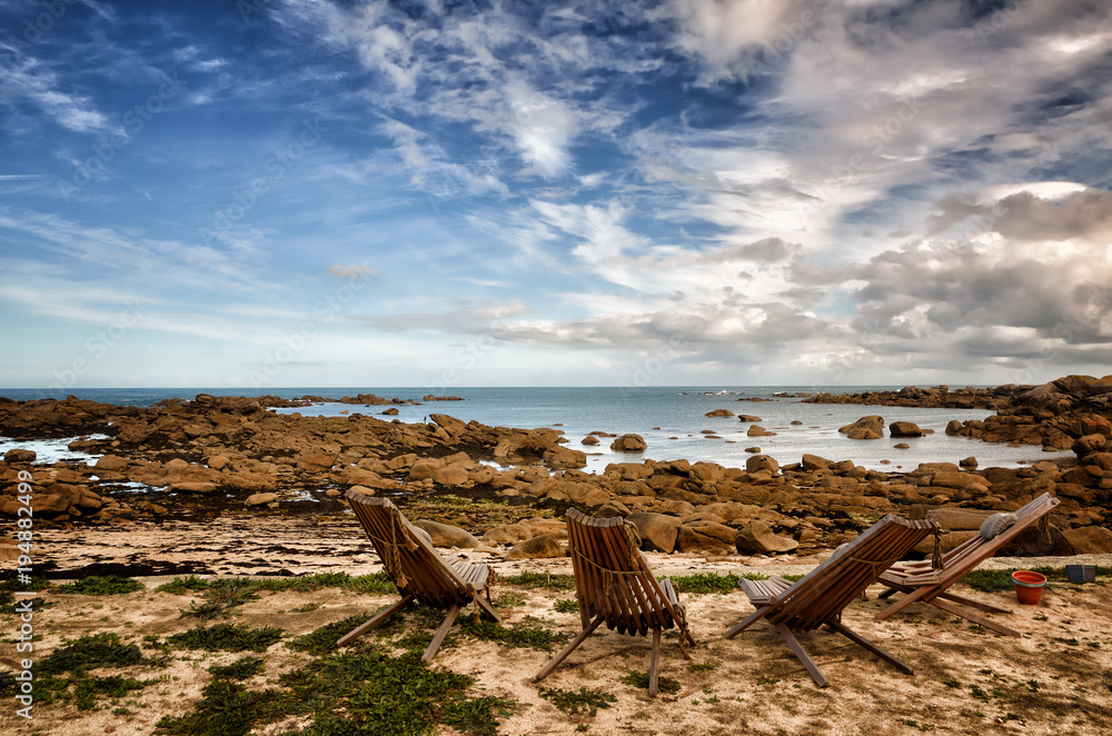 Beach chair in front beautiful rocky beach in Brittany, France