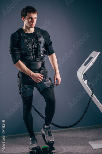 Caucasian man wearing ems suit training on stepper photo