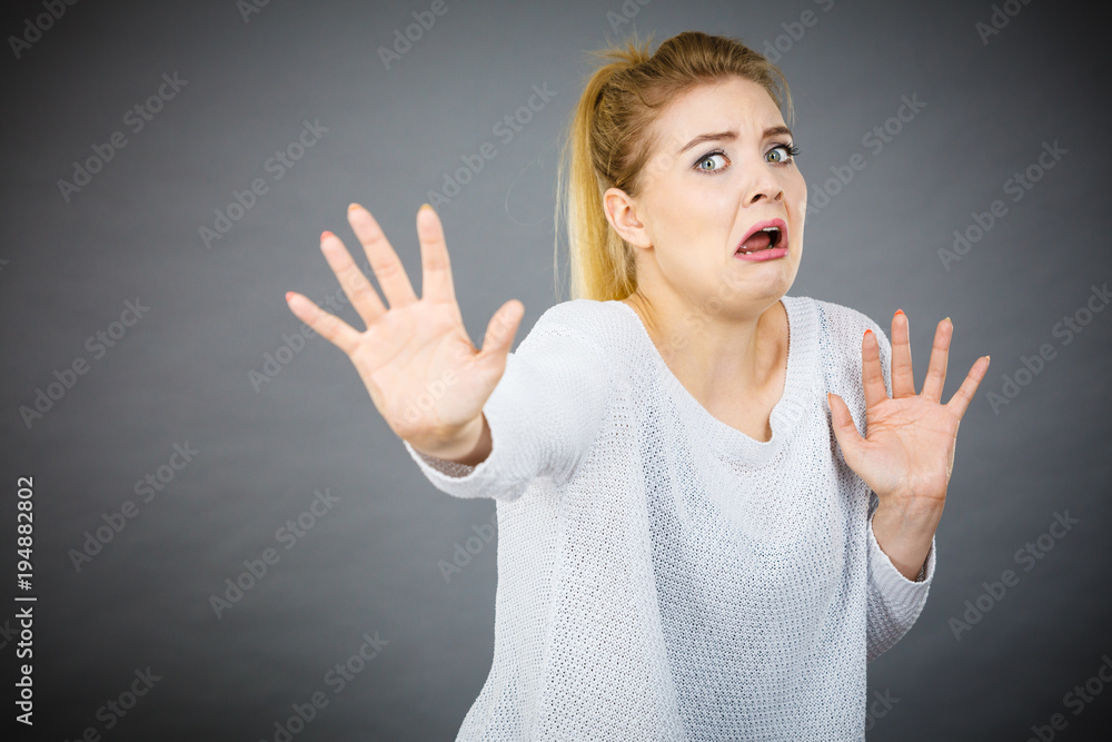 Scared woman gesturing stop gesture with hands Scared woman gesturing stop gesture with hands