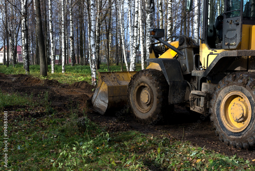 a bulldozer clears the site for construction a bulldozer clears the site for construction