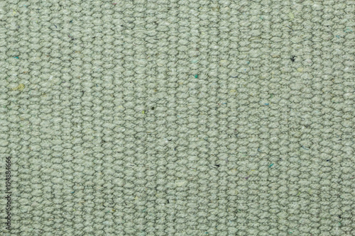 The texture of the fabric is light olive-colored. Background.