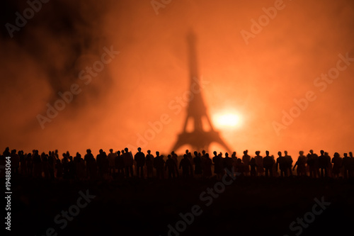 Silhouettes of a crowd standing at field behind the blurred foggy background. Revolution, people protest against government, man fighting for rights