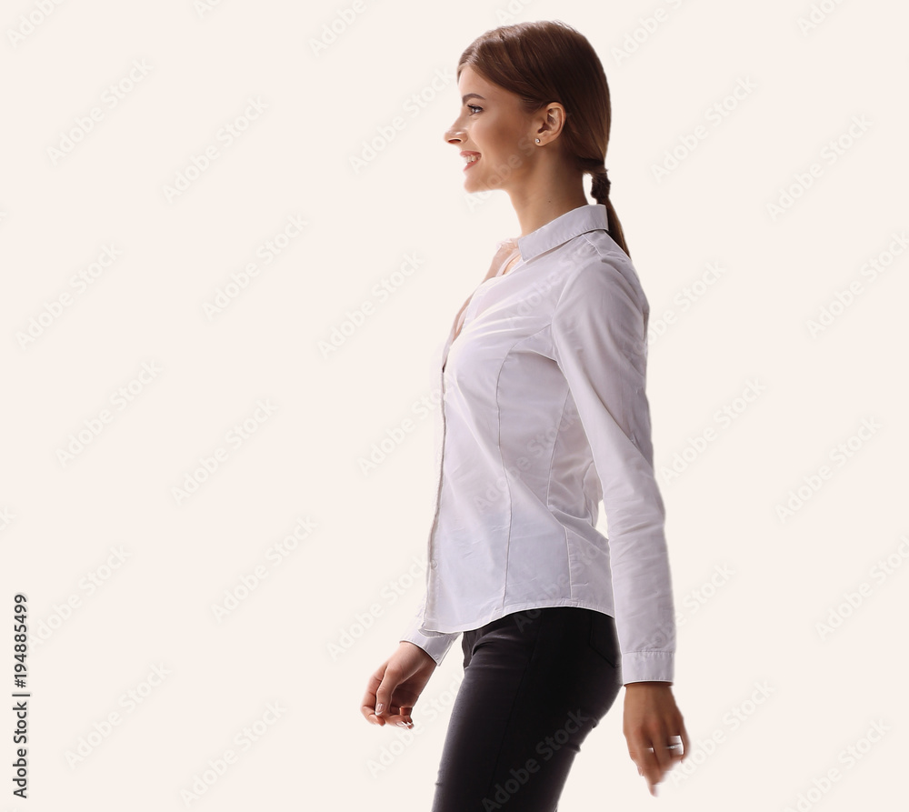 side view.in full growth.confident young woman is moving forward confidently. side view.in full growth.confident young woman is moving forward confidently.