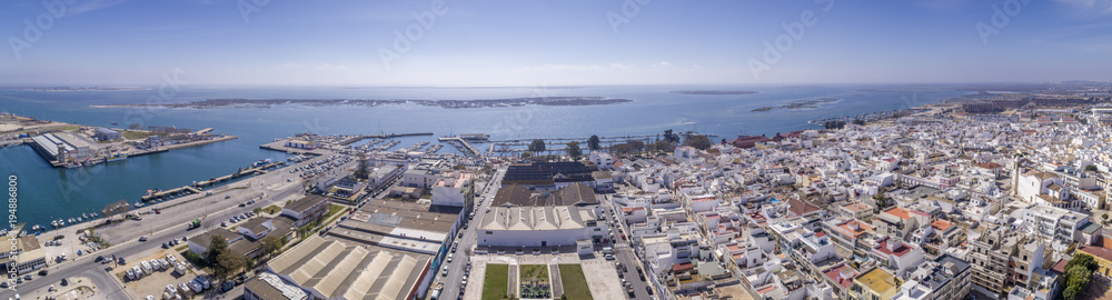 Aerial daytime view of Olhao downtown and Marina seascape, waterfront to Ria Formosa natural park. Algarve.