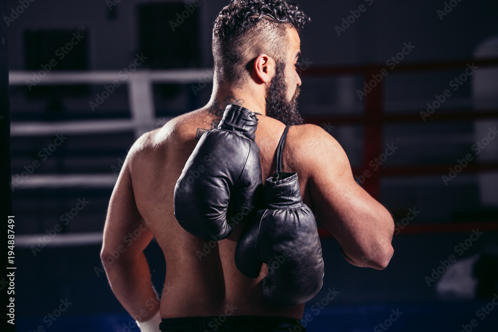 Young muscular man boxer. Boxing gloves slung over his shoulder Photos |  Adobe Stock