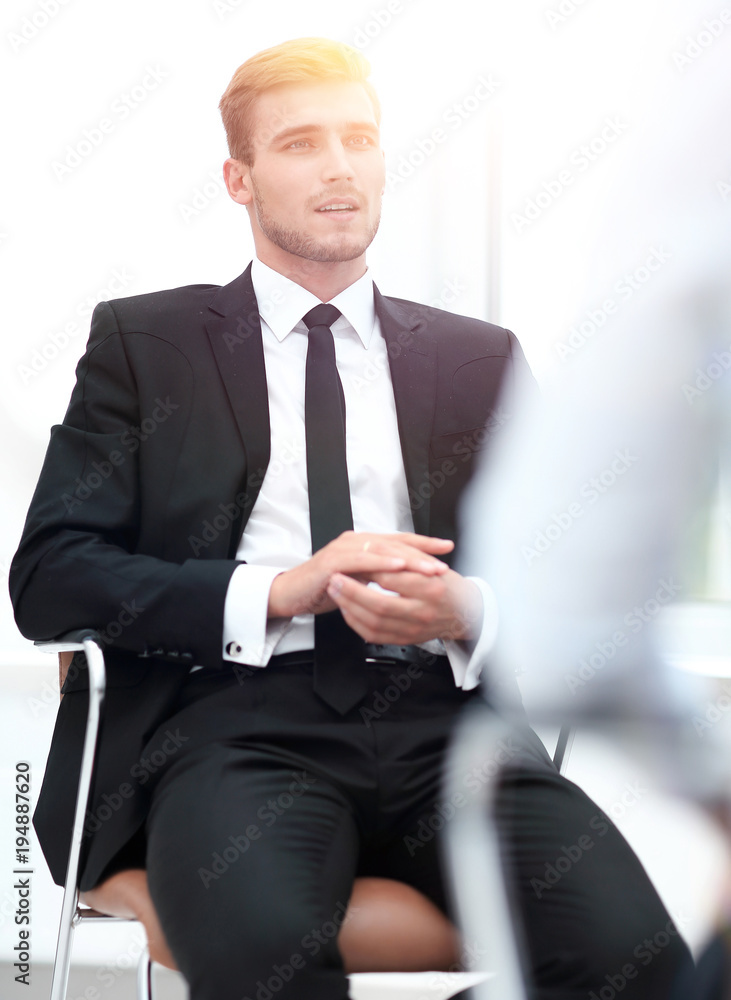 closeup . serious businessman sitting in an office chair. closeup . serious businessman sitting in an office chair.