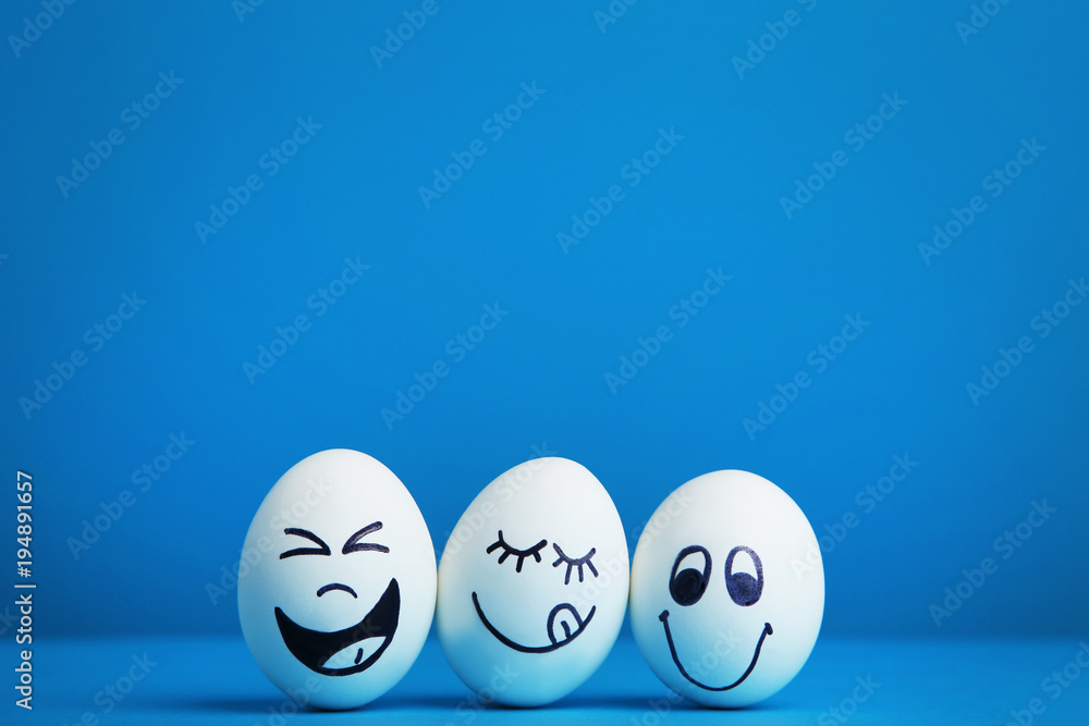 Eggs with funny faces on blue background - obrazy, fototapety, plakaty 