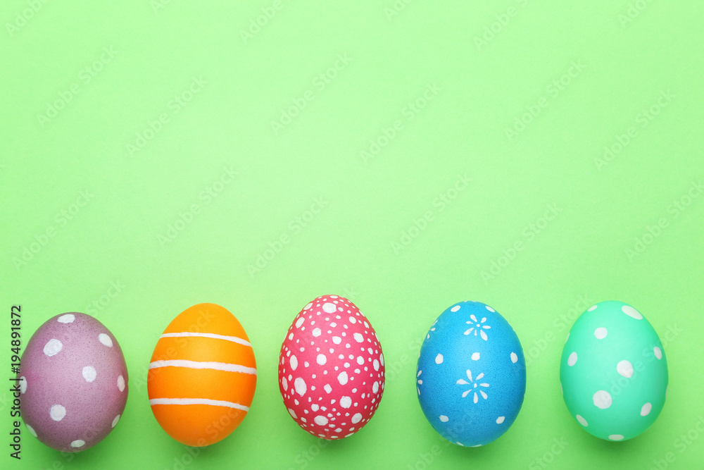 Colorful easter eggs on green background