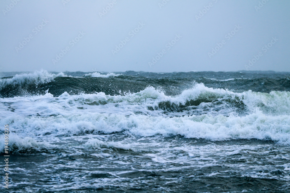 Sea waves breaking during strong wind 