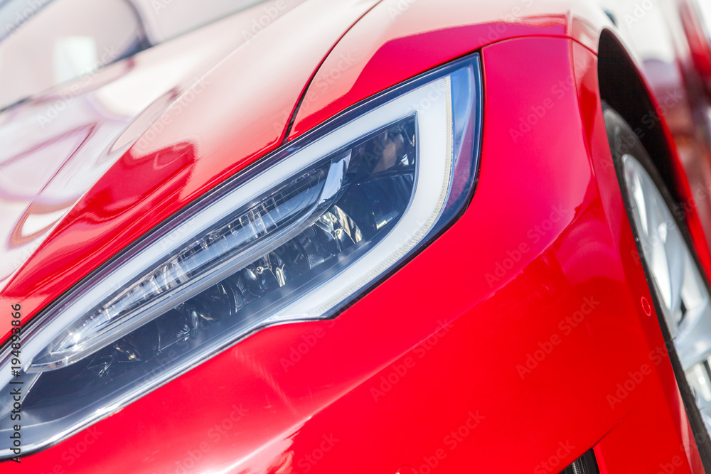 shiny headlights on a red sports car