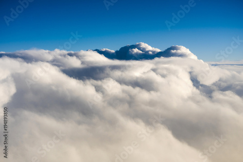 Fototapeta View over clouds from an airplane