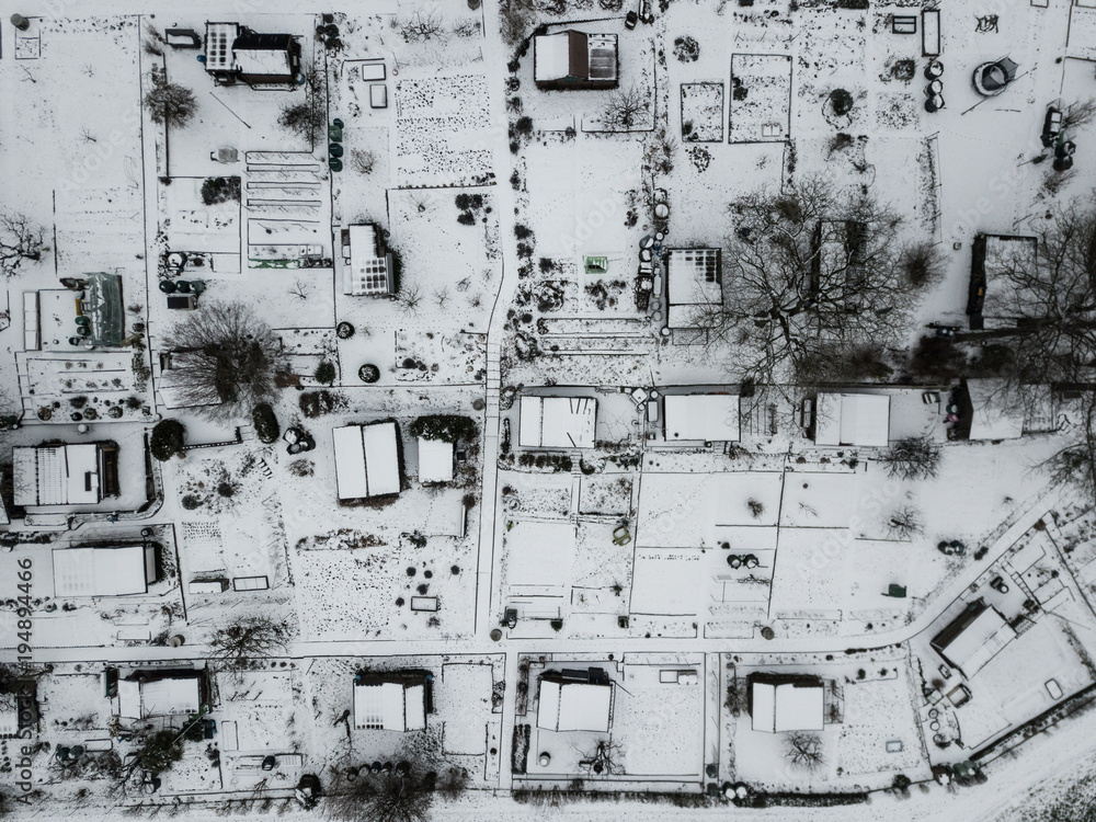 Aerial view of allotment covered in snow with tiny houses