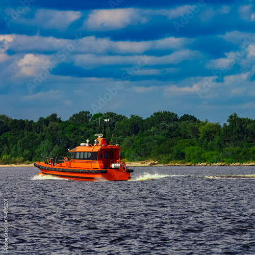 Orange pilot boat in action