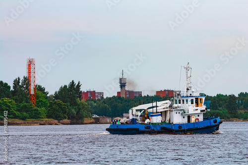 Blue tug ship underway