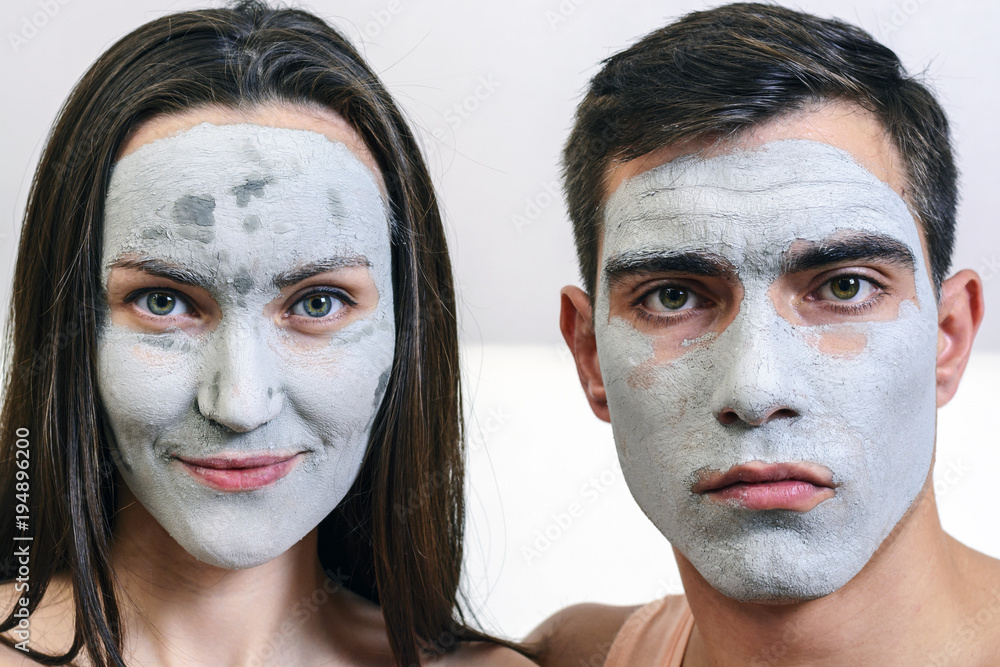 Emotional large portrait of a married couple in masks for the face of clay. day Spa, Wellness, skincare Emotional large portrait of a married couple in masks for the face of clay. day Spa, Wellness, skincare