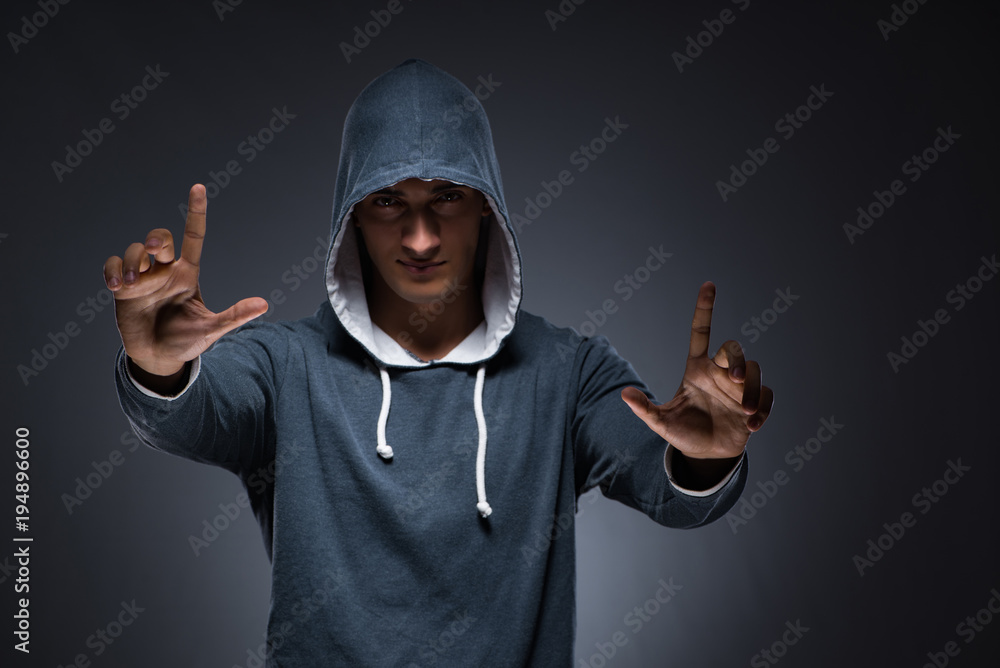 Young man wearing hoodie pressing virtual buttons Young man wearing hoodie pressing virtual buttons