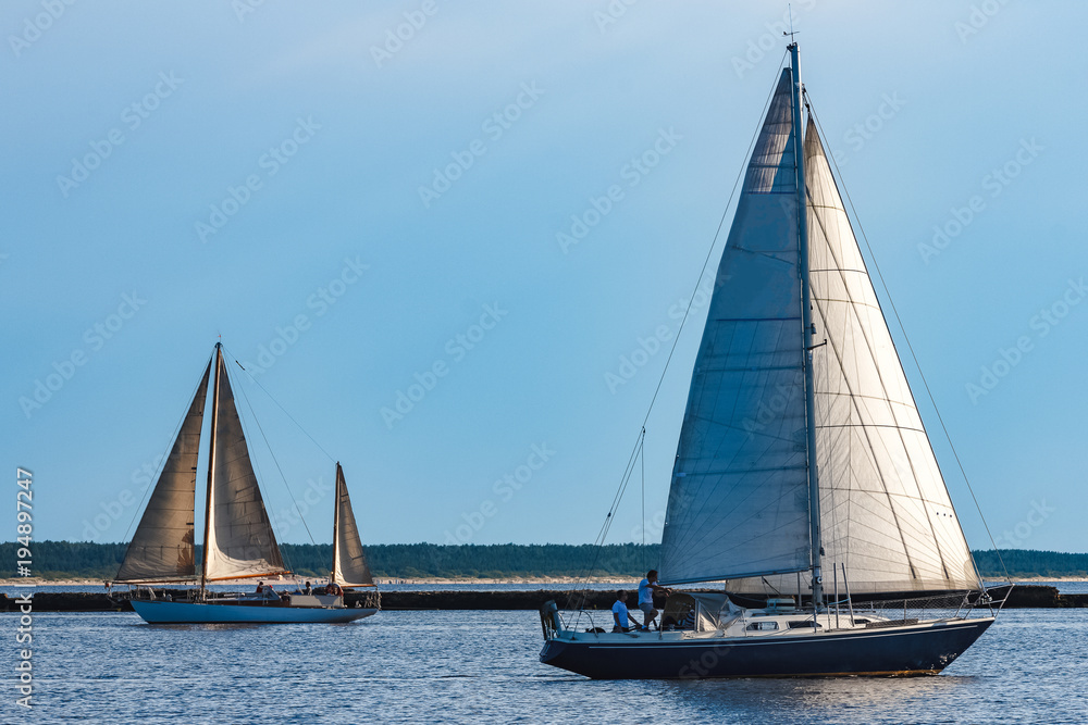 Fototapeta premium Blue sailboat at river