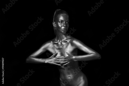 sexy slender lady painted with silver paint