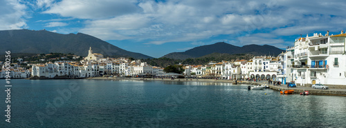 long panorama sur un village typique méditerranéen avec façades blanches et mer bleue