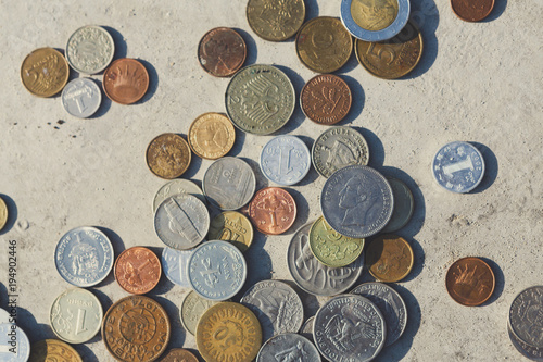 Coins mix fall out of glass jar on floor