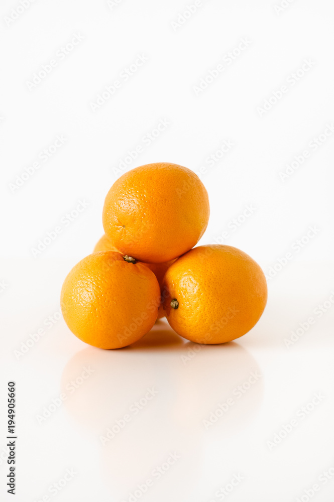 Stack of fresh, ripe, sweet and juicy, organic oranges on white background Stack of fresh, ripe, sweet and juicy, organic oranges on white background