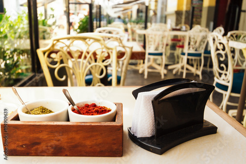 Spice and napkin holder on the table of a restaurant