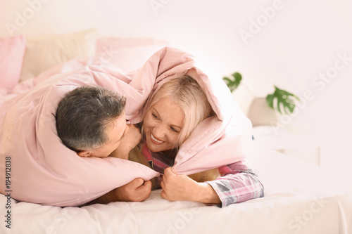 Senior couple under blanket...