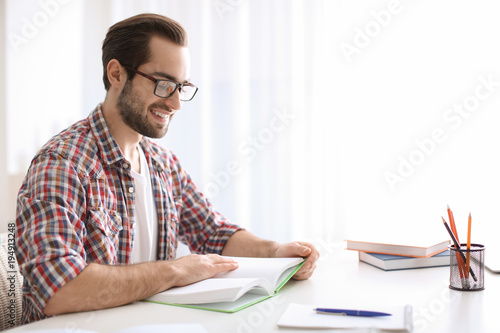 Student studying at table indoors