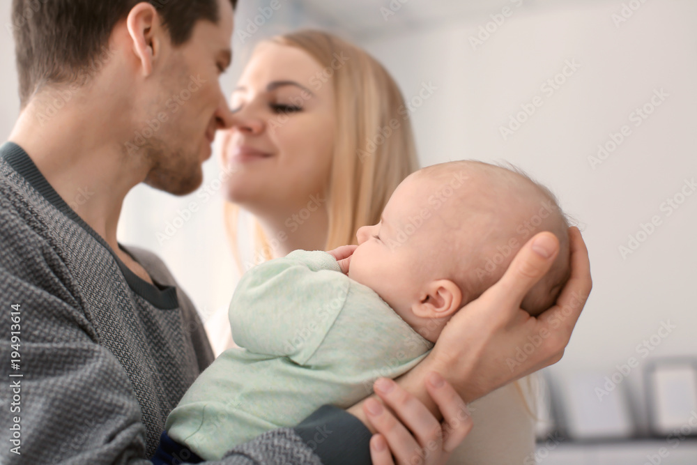 Young parents with sleeping baby at home Young parents with sleeping baby at home