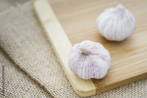 garlic bulbs on wood, selective focus