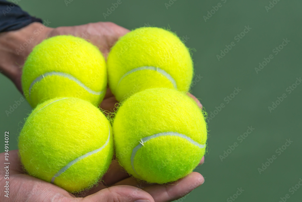 Tennis balls in hand.