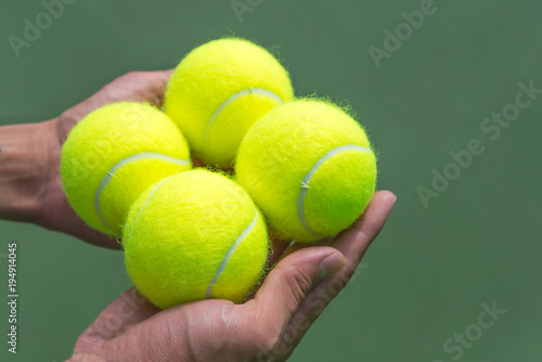 Tennis balls in hand. © pomphotothailand
