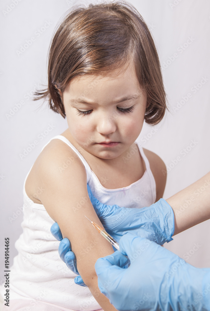 Nurse vaccinating 3 years old little girl Nurse vaccinating 3 years old little girl