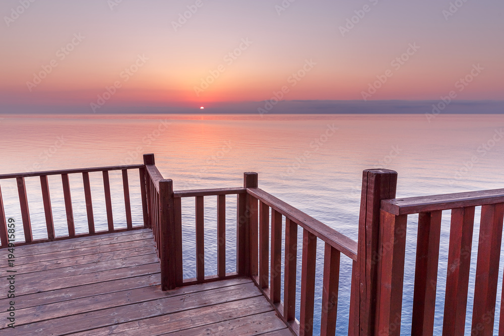 Picturesque Viewpoint on sunset seascape over Mediterranean sea in European country from wooden terrace.