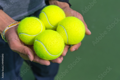 Tennis balls in hand. © pomphotothailand