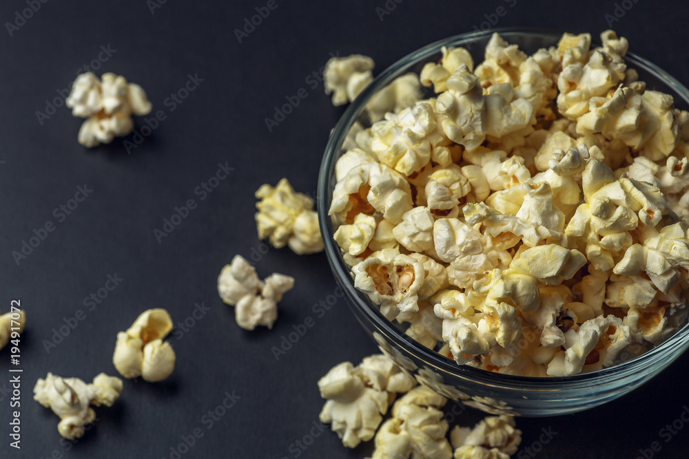 Popcorn in glass bowl on dark background, copy space Popcorn in glass bowl on dark background, copy space