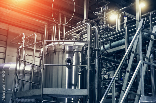 Stainless steel brewing equipment : large reservoirs or tanks and pipes in modern beer factory