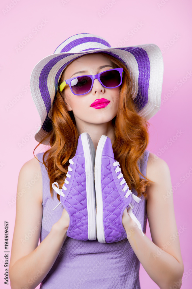 girl in sunglasses and hat holding shoes girl in sunglasses and hat holding shoes
